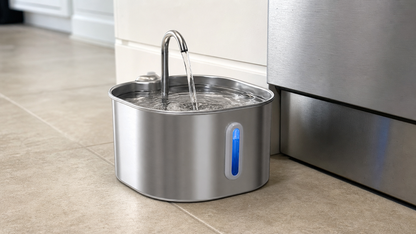 Cat water fountain on a kitchen tile floor beside a dishwasher